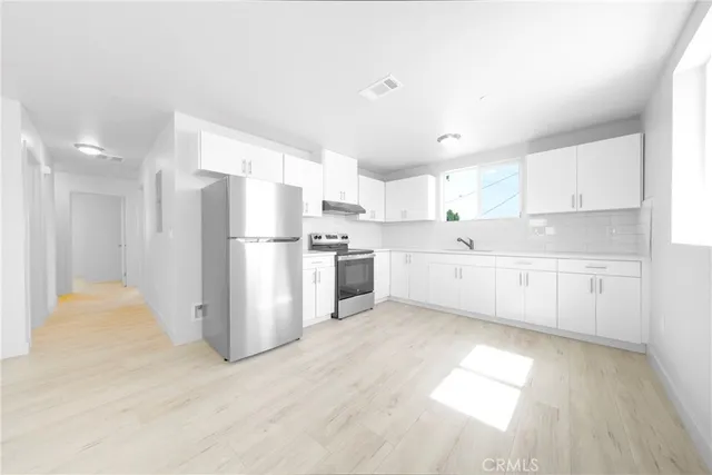 a view of a kitchen with electric appliances