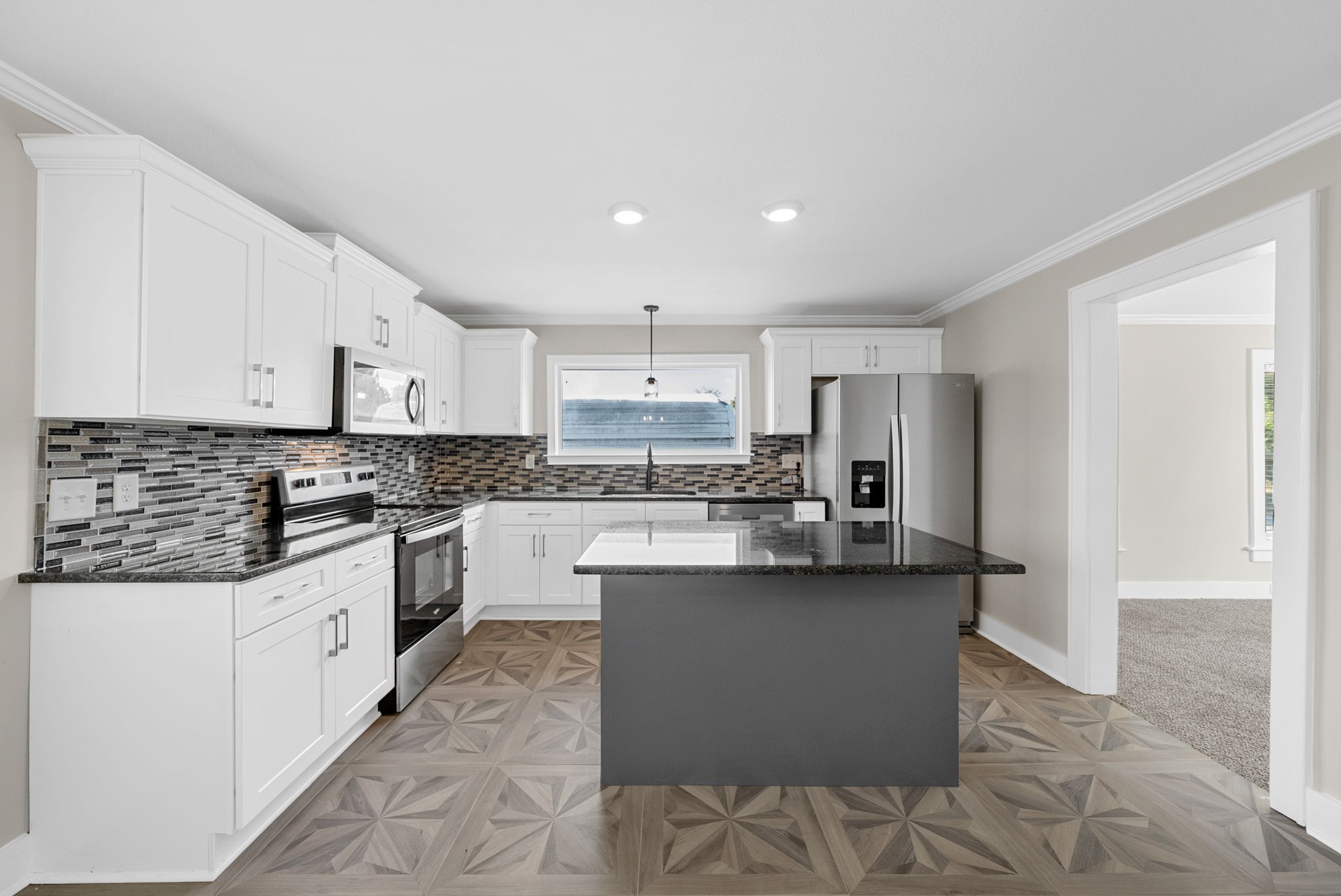 2021 Powell Road Clarksville, TN 37043 - Photo 8 of 31 a kitchen with stainless steel appliances granite countertop a refrigerator a sink dishwasher a stove and white countertops with wooden floor