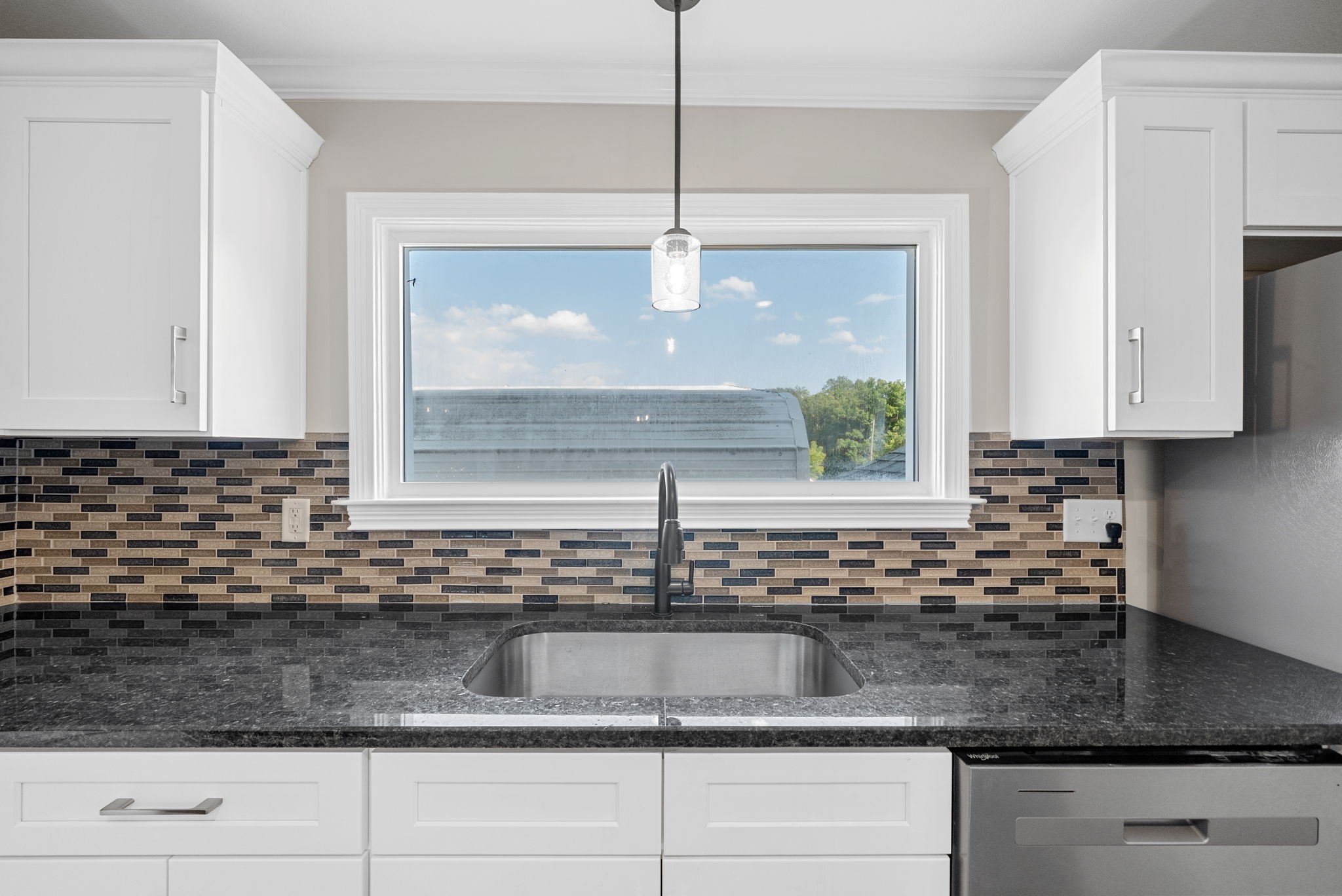 2021 Powell Road Clarksville, TN 37043 - Photo 10 of 31 a kitchen with granite countertop a sink a window and cabinets