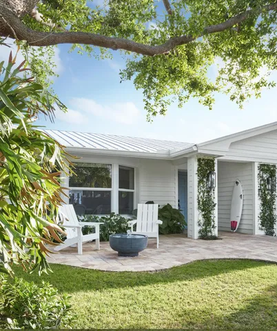 a view of a house with backyard porch and sitting area