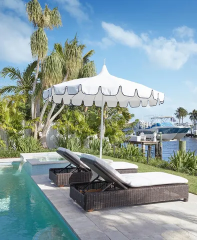 a view of a lake with couches chairs and a table