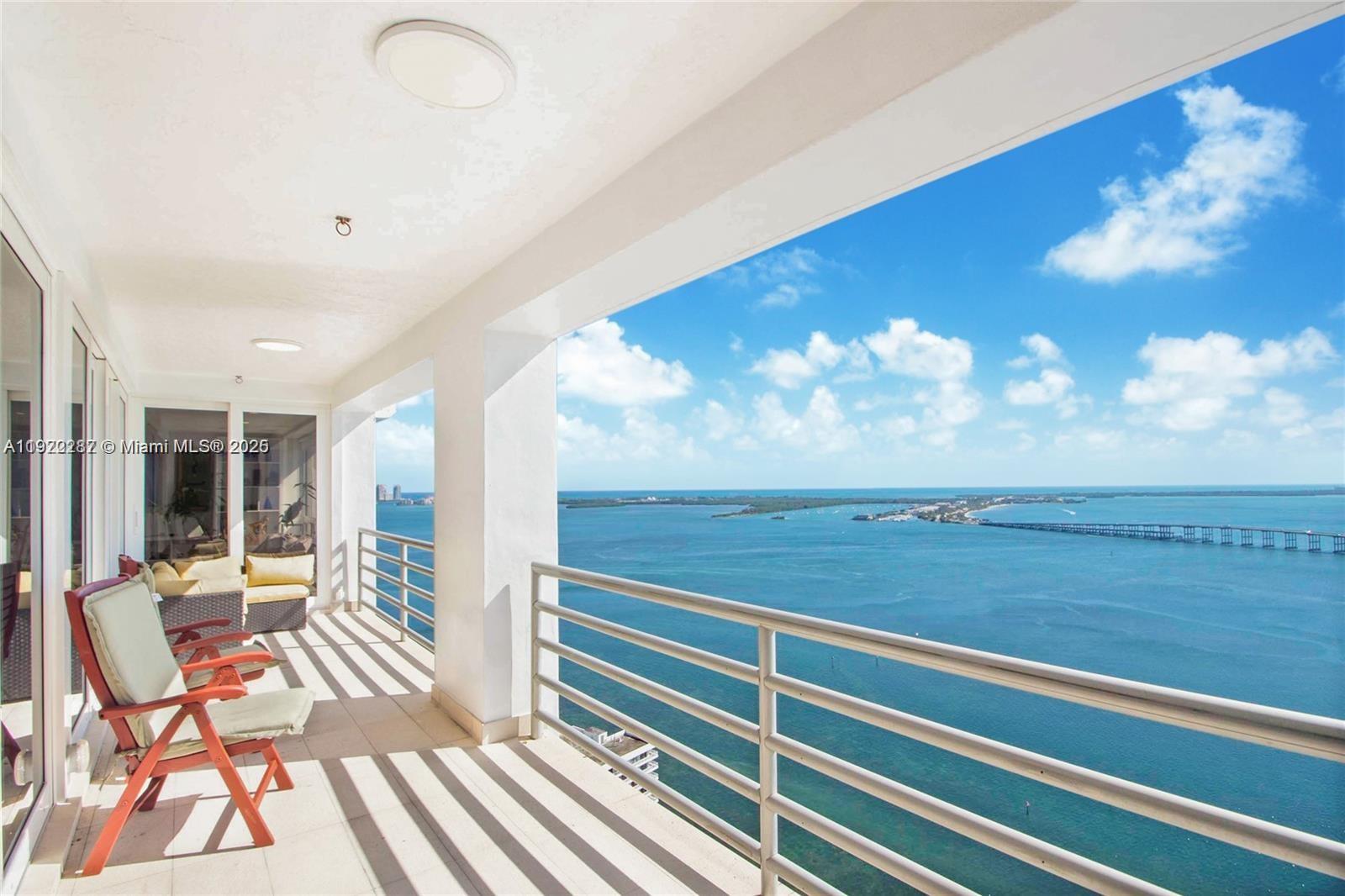 1541 Brickell Avenue, Unit A3902 Miami, FL 33129 - Photo 1 of 24 a view of a balcony with chair and table