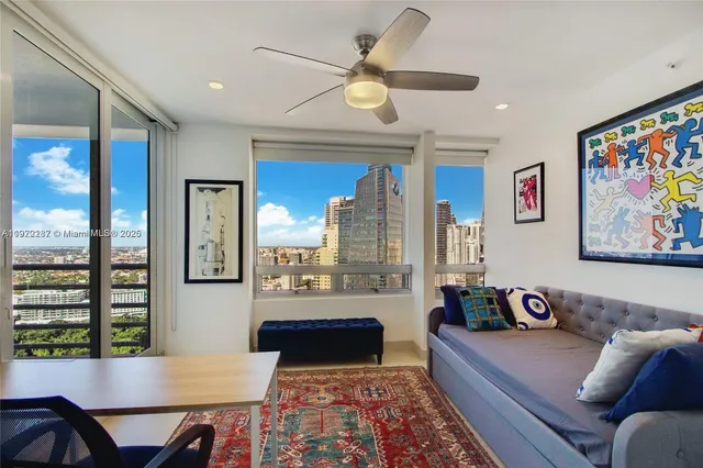 a living room with furniture and a large window