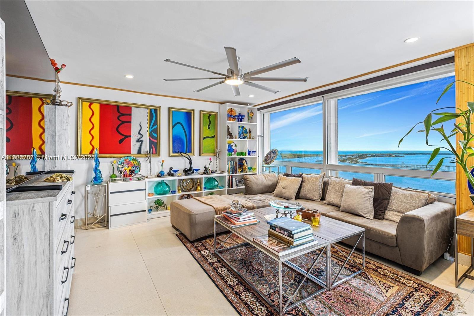 1541 Brickell Avenue, Unit A3902 Miami, FL 33129 - Photo 12 of 24 a living room with furniture ceiling fan and a large window