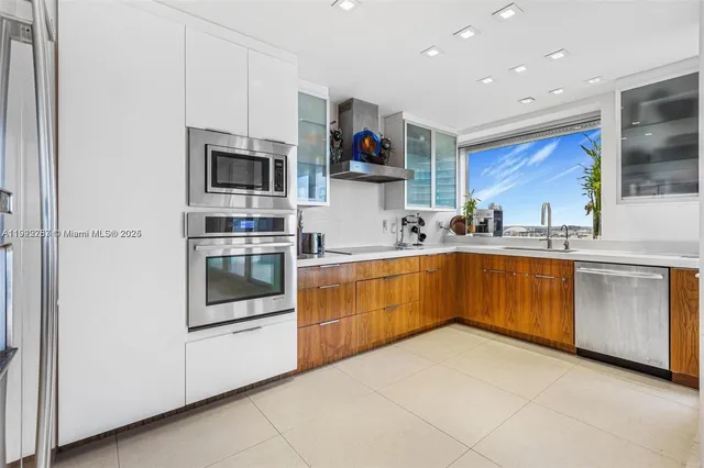 a kitchen with stainless steel appliances a stove microwave and cabinets