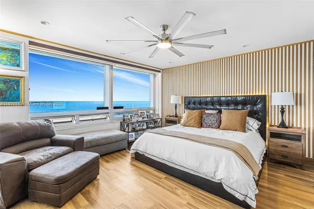 a bedroom with furniture and a large window