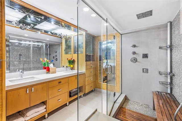 a spacious bathroom with a glass shower door and a mirror