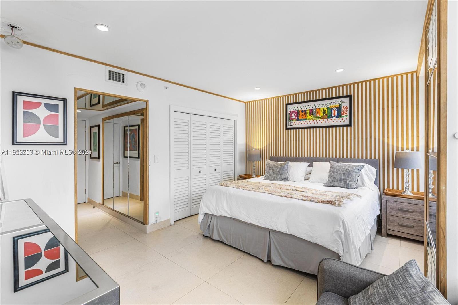 1541 Brickell Avenue, Unit A3902 Miami, FL 33129 - Photo 19 of 24 a spacious bedroom with a bed and a refrigerator