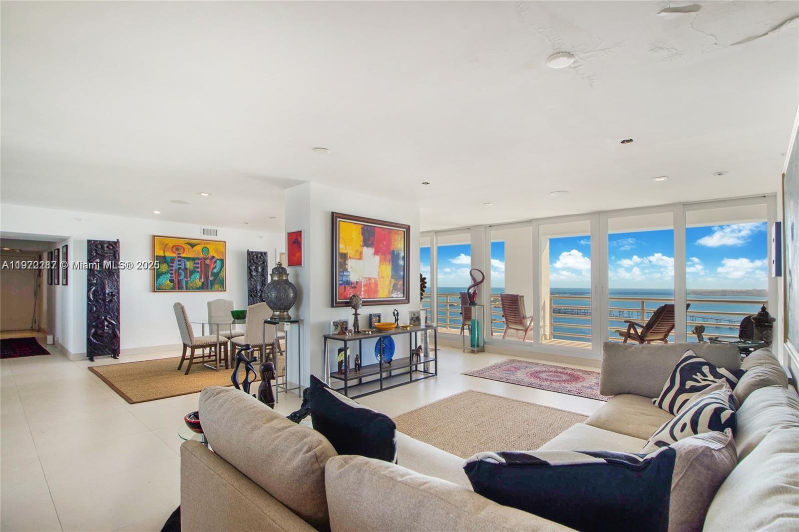 1541 Brickell Avenue, Unit A3902 Miami, FL 33129 - Photo 2 of 24 a living room with furniture and a flat screen tv