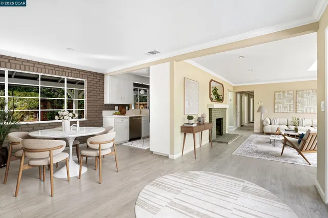 a view of empty room with wooden floor and fireplace