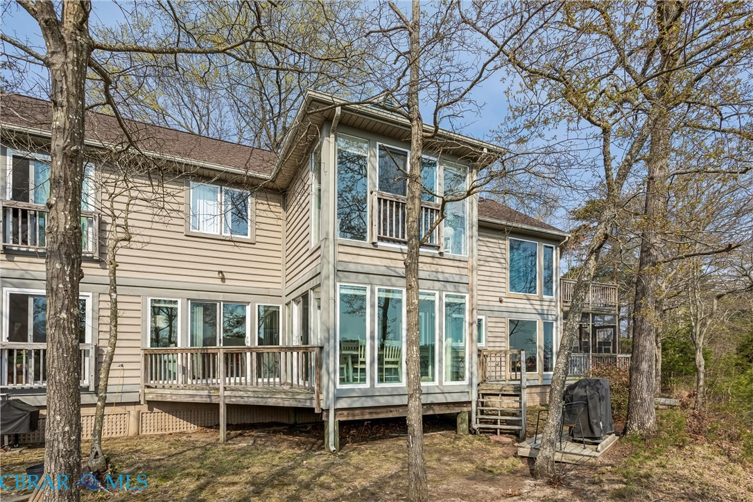 172 Sturgeon Creek Road Deltaville, VA 23043 - Photo 35 of 50 Back of house with a wooden deck and a sunroom