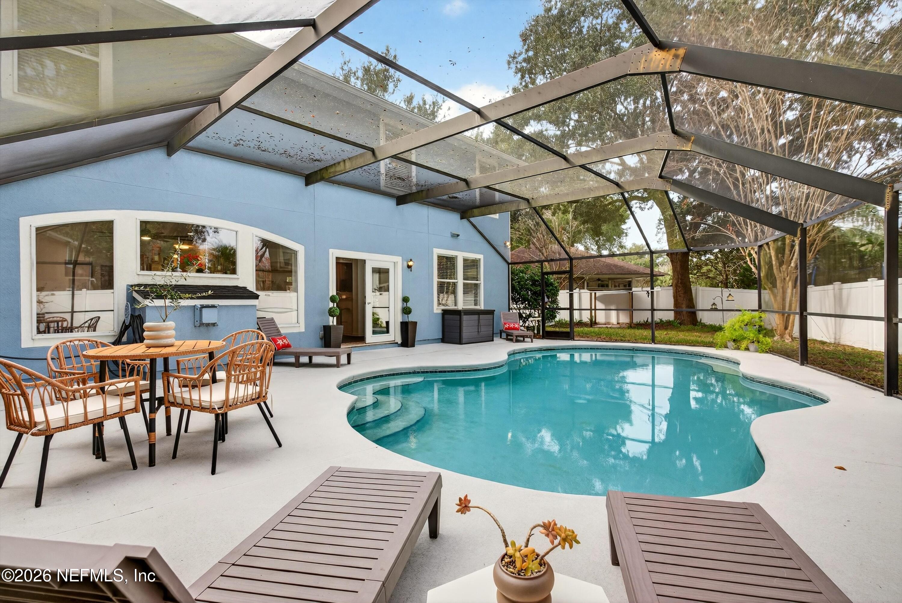 a view of a swimming pool with chairs