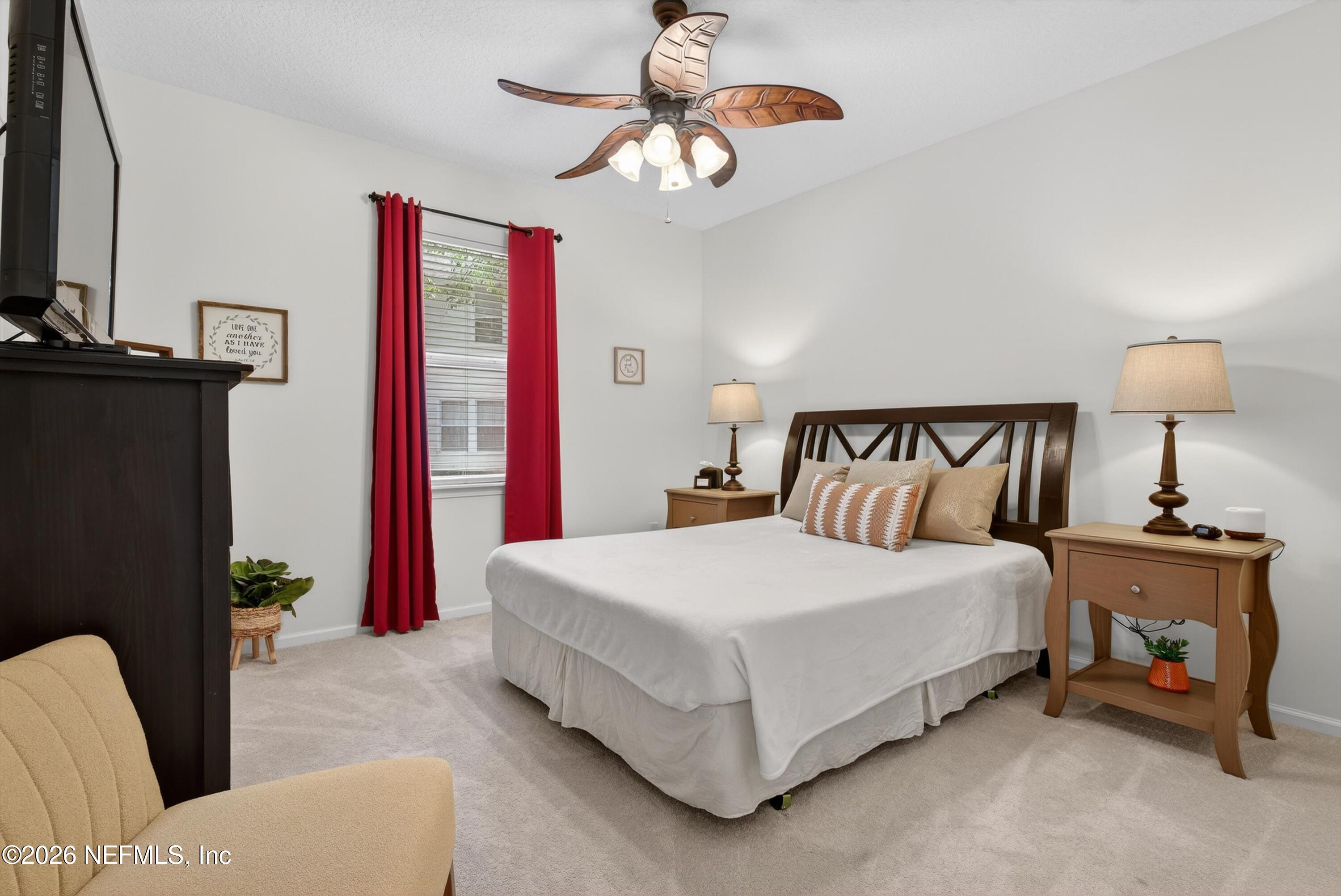 1214 South Kyle Way St. Johns, FL 32259 - Photo 35 of 78 a bedroom with a bed a couch and a chandelier