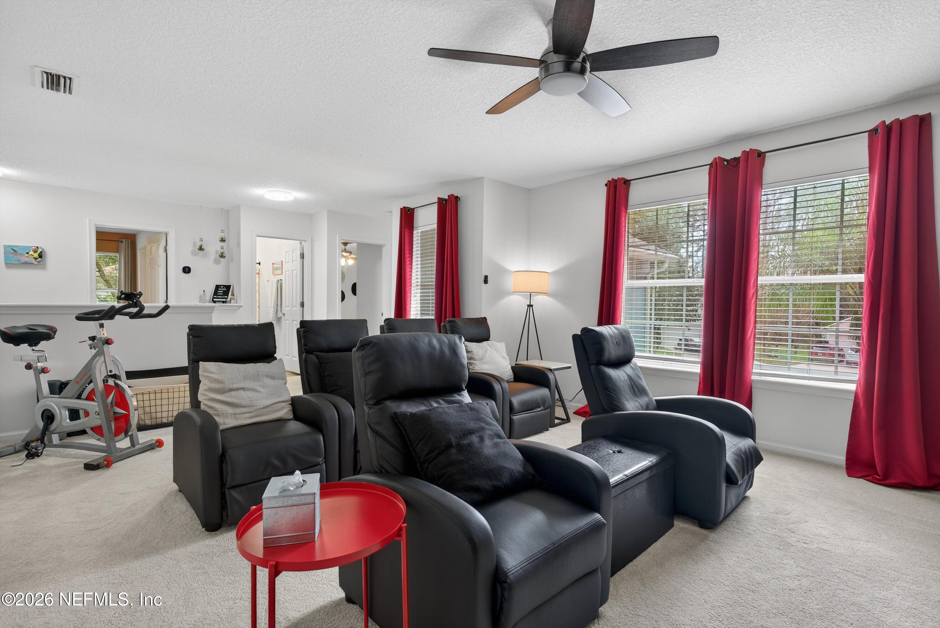 1214 South Kyle Way St. Johns, FL 32259 - Photo 38 of 78 a living room with furniture a flat screen tv and a large window