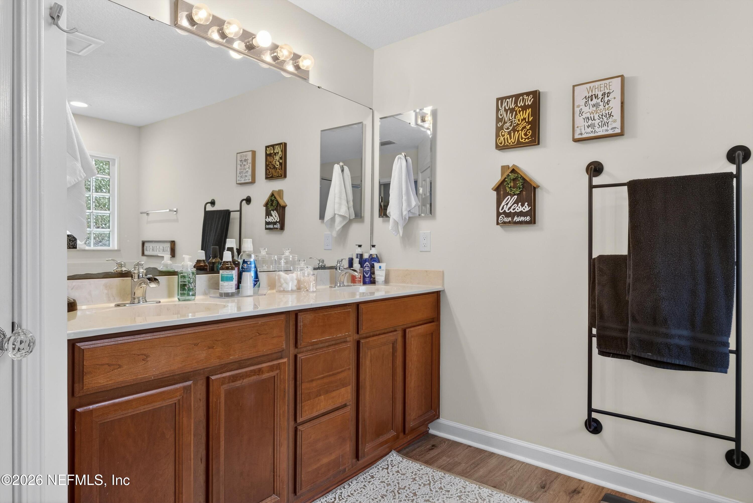 1214 South Kyle Way St. Johns, FL 32259 - Photo 42 of 78 a bathroom with a sink a mirror a shower and vanity