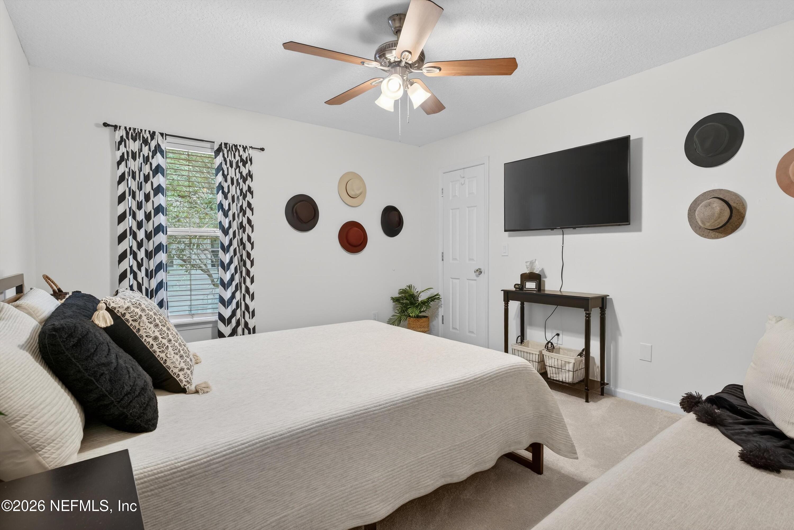 1214 South Kyle Way St. Johns, FL 32259 - Photo 51 of 78 a bedroom with a bed and a flat tv screen on the dresser