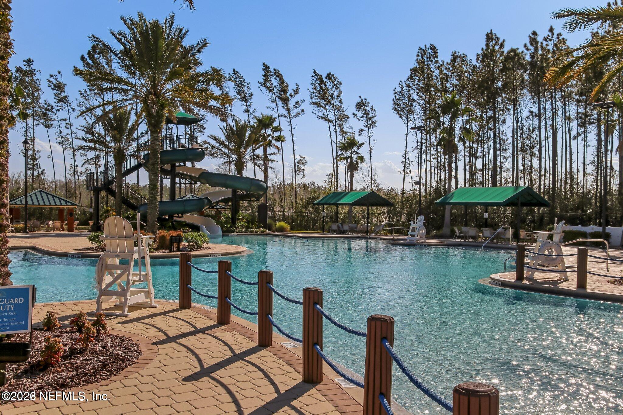 1214 South Kyle Way St. Johns, FL 32259 - Photo 76 of 78 a view of a lake with a table and chairs
