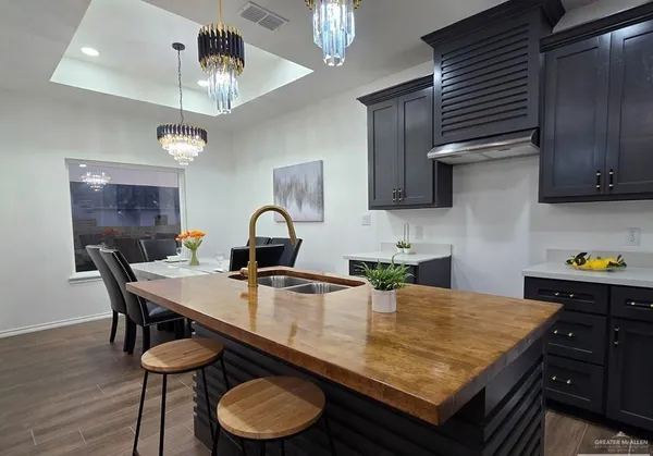 a kitchen with a table chairs and cabinets