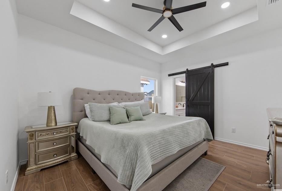 18002 Spruce Street Harlingen, TX 78552 - Photo 13 of 29 a bedroom with a bed and wooden floor