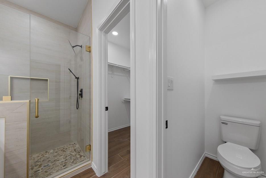 18002 Spruce Street Harlingen, TX 78552 - Photo 17 of 29 a bathroom with a granite countertop shower and toilet