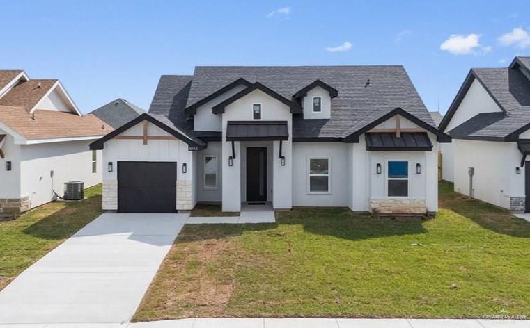 18002 Spruce Street Harlingen, TX 78552 - Photo 2 of 29 a front view of a house with a yard and garage