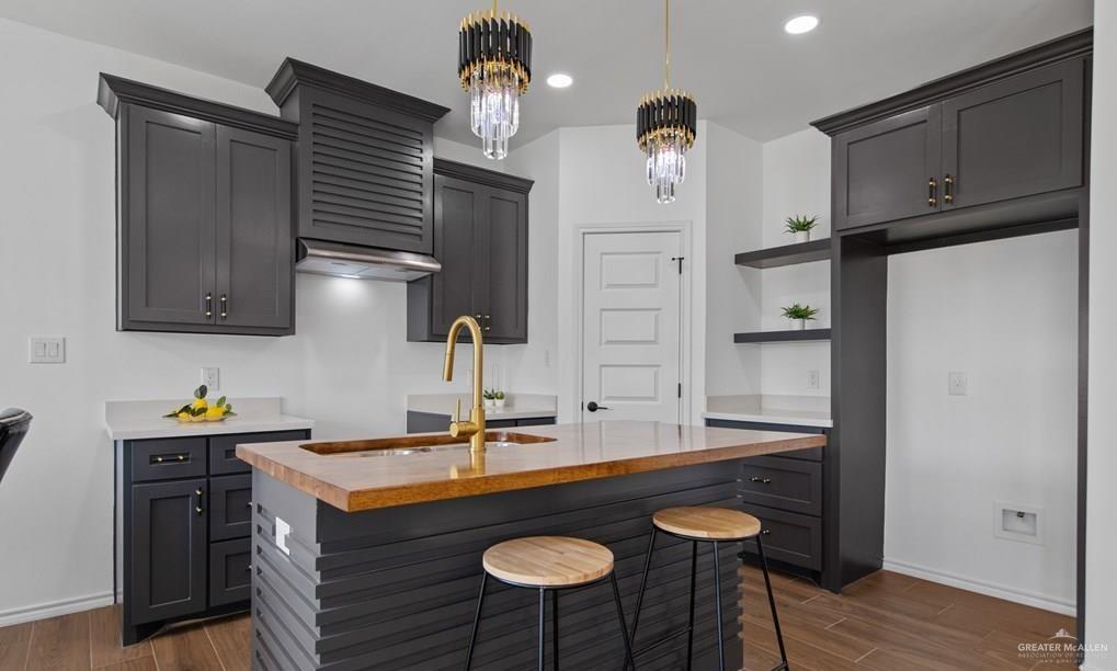 18002 Spruce Street Harlingen, TX 78552 - Photo 9 of 29 a kitchen with stainless steel appliances granite countertop a sink a stove and a refrigerator