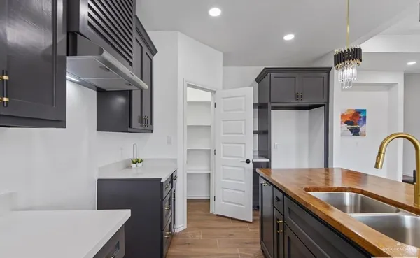 a kitchen with kitchen island a sink stainless steel appliances and cabinets