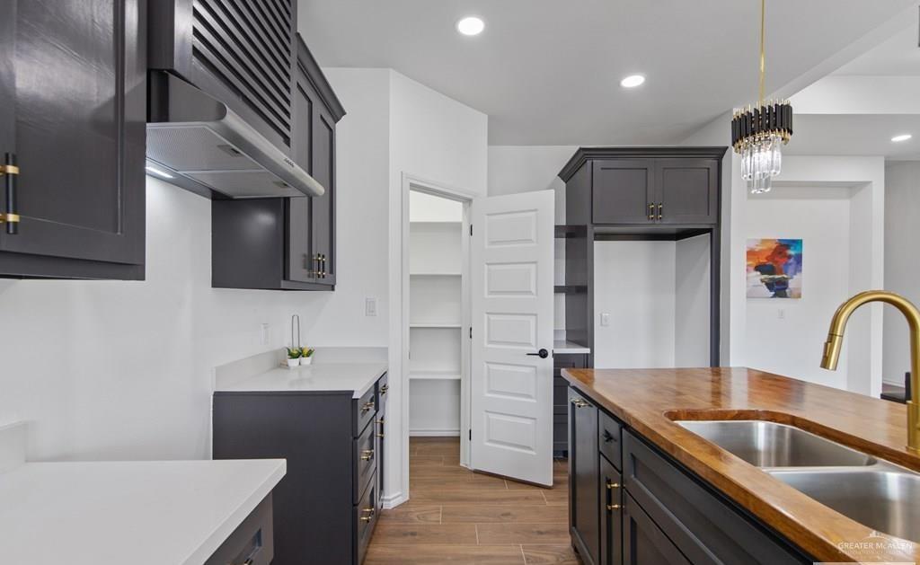 18002 Spruce Street Harlingen, TX 78552 - Photo 10 of 29 a kitchen with kitchen island a sink stainless steel appliances and cabinets
