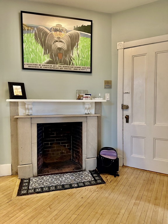 49 Grove Street, Unit 4 Newton, MA 02466 - Photo 12 of 19 a living room with furniture and a fireplace