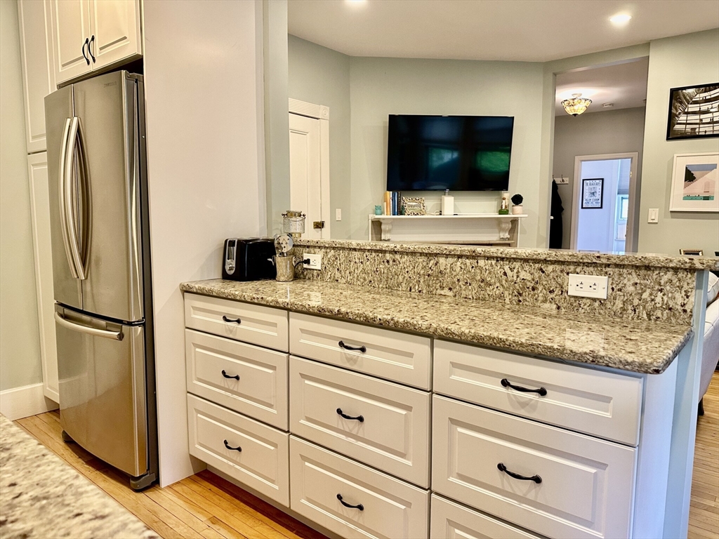 49 Grove Street, Unit 4 Newton, MA 02466 - Photo 13 of 19 a living room with granite countertop furniture and a flat screen tv