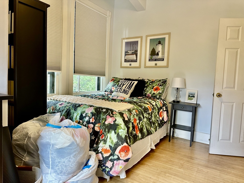 49 Grove Street, Unit 4 Newton, MA 02466 - Photo 16 of 19 a bed sitting in a bedroom next to a window