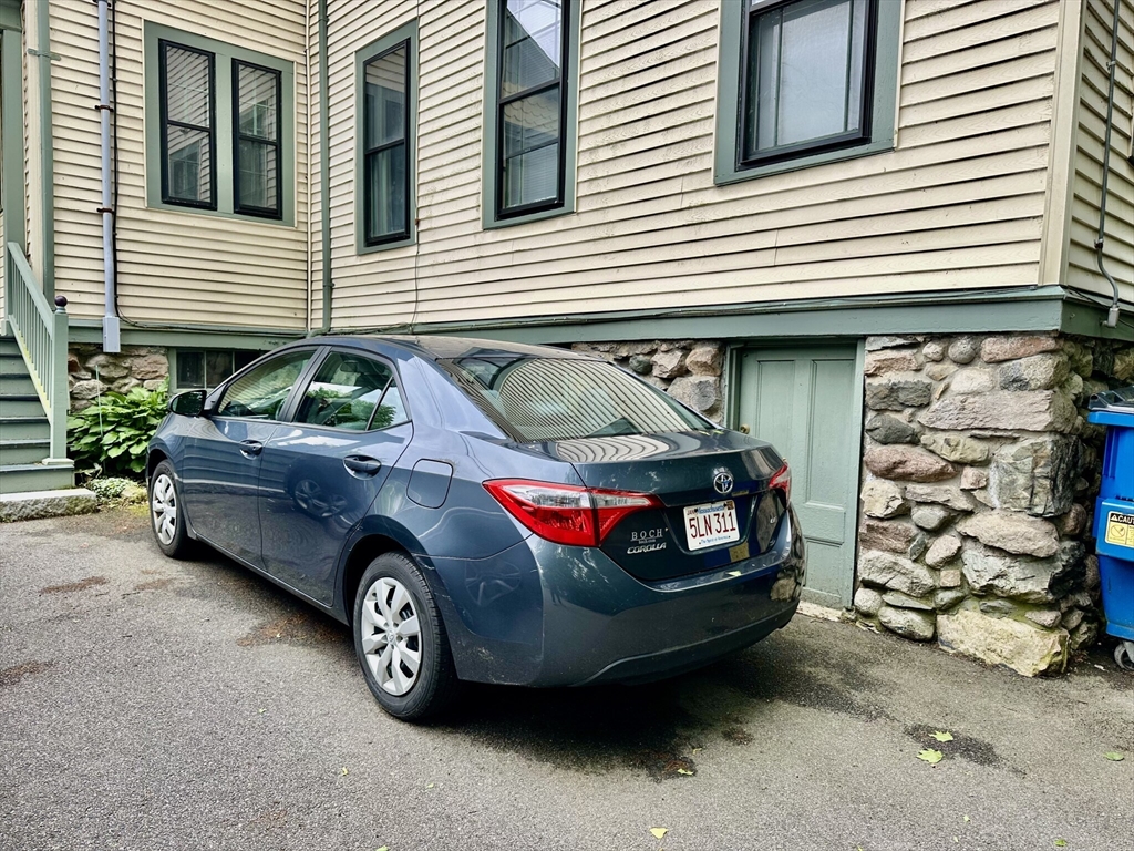 49 Grove Street, Unit 4 Newton, MA 02466 - Photo 19 of 19 a car parked in front of a house