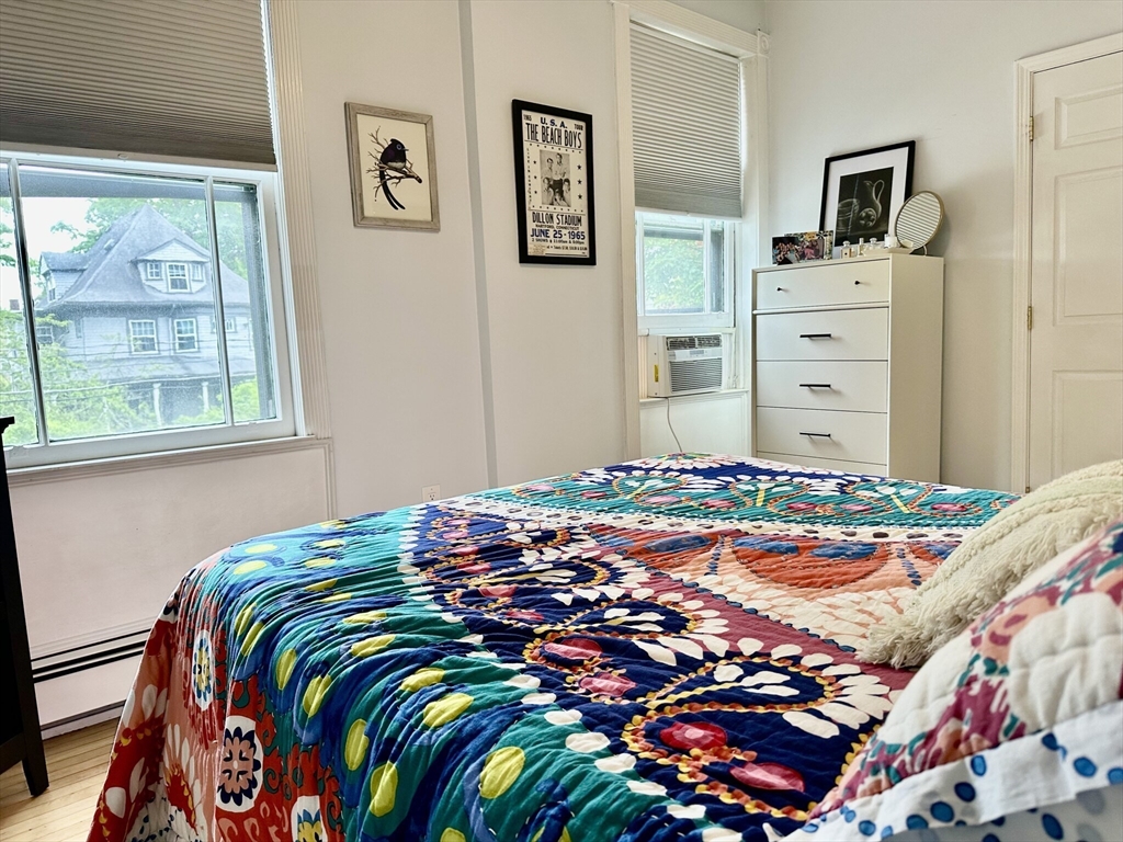 49 Grove Street, Unit 4 Newton, MA 02466 - Photo 3 of 19 a bedroom with a bed and a window