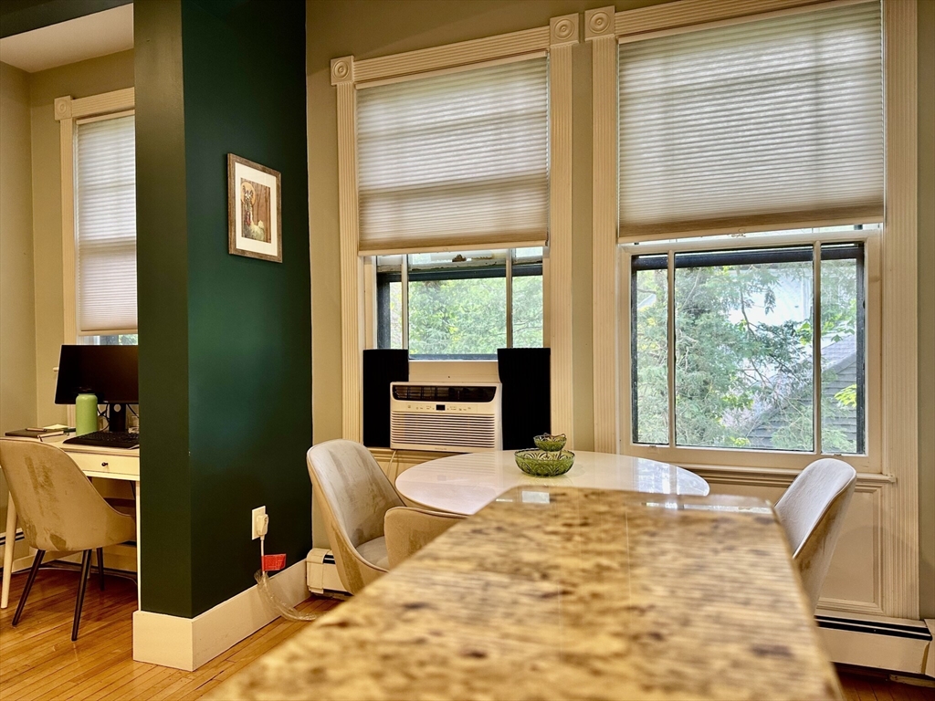 49 Grove Street, Unit 4 Newton, MA 02466 - Photo 4 of 19 a room with a bed and large windows