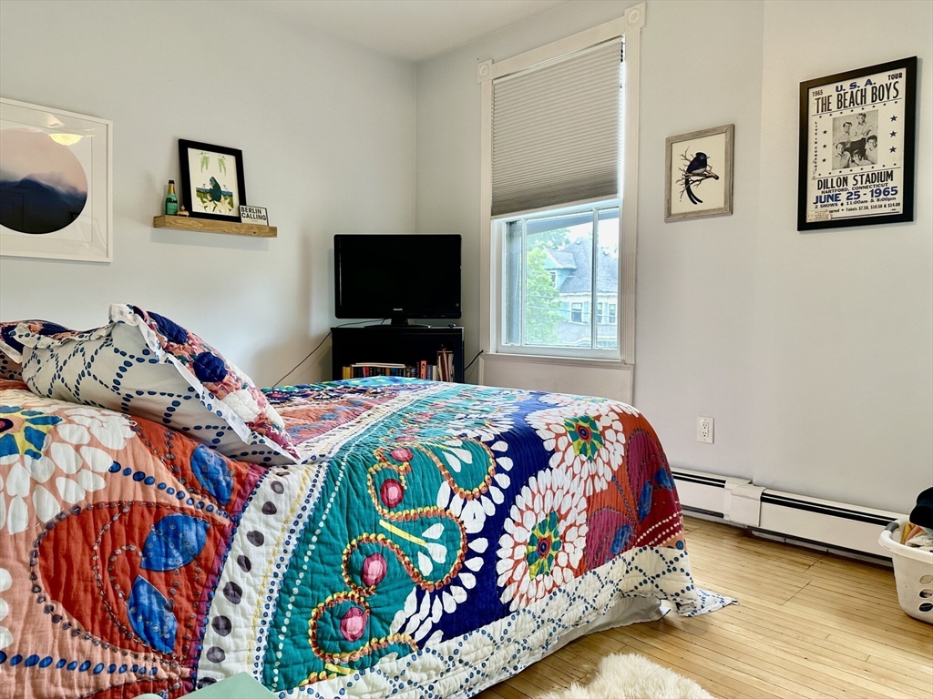 49 Grove Street, Unit 4 Newton, MA 02466 - Photo 7 of 19 a bedroom that has a bed and a tv in it