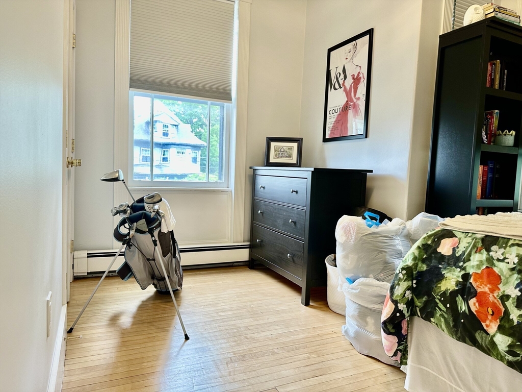 49 Grove Street, Unit 4 Newton, MA 02466 - Photo 9 of 19 a bedroom with furniture and a closet