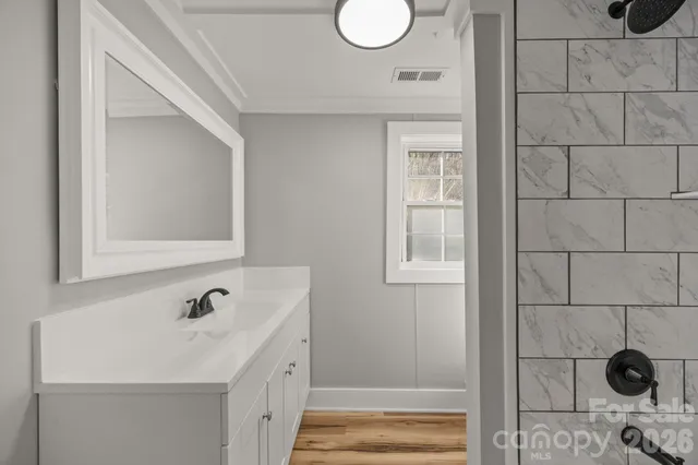 a bathroom with a sink and a window