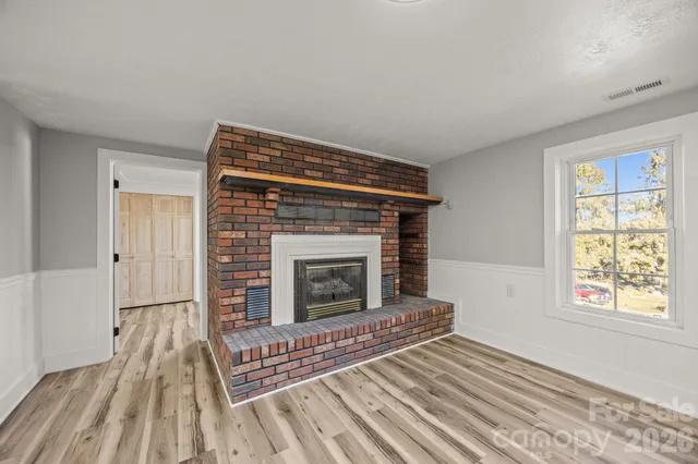 a living room with a fireplace and a rug