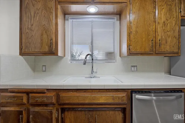 a kitchen with a sink cabinets and wooden floor