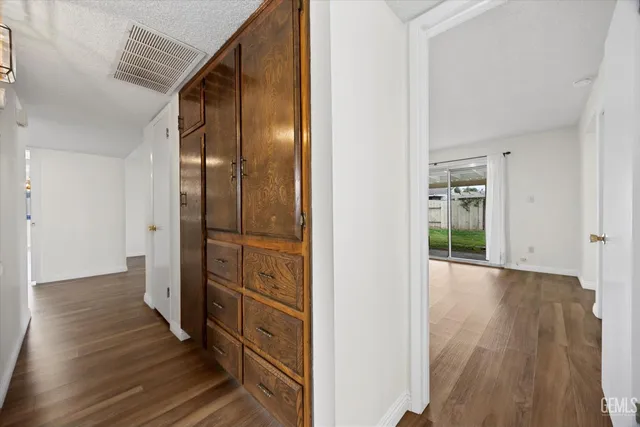 a view of a hallway with wooden floor and staircase