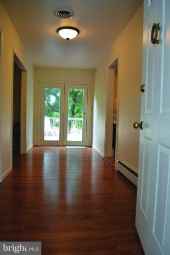 3355 Uniontown Road Westminster, MD 21158 - Photo 11 of 21 an empty room with wooden floor and windows