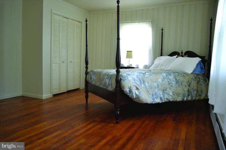 3355 Uniontown Road Westminster, MD 21158 - Photo 13 of 21 a room with wooden floor and a mirror