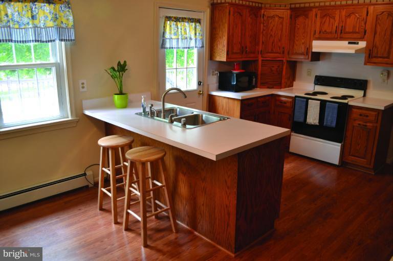 3355 Uniontown Road Westminster, MD 21158 - Photo 7 of 21 a view of a dining room with furniture and wooden floor