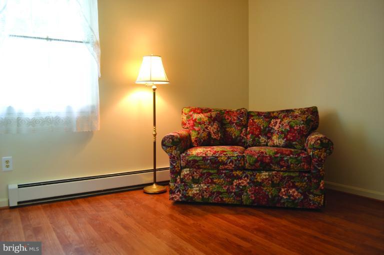 3355 Uniontown Road Westminster, MD 21158 - Photo 8 of 21 a living room with a couch and a chandelier