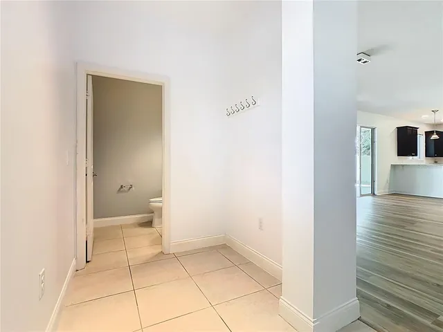 an empty room with wooden floor a ceiling fan and closet