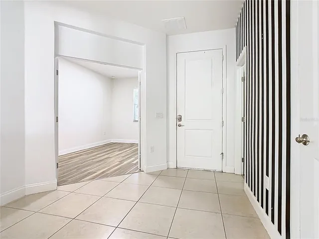 a view of a room with wooden floor and a window