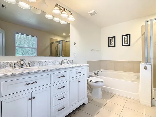 a view of a house with a yard and potted plants
