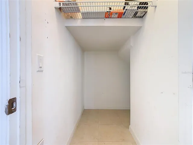 a view of a house with a yard and large tree