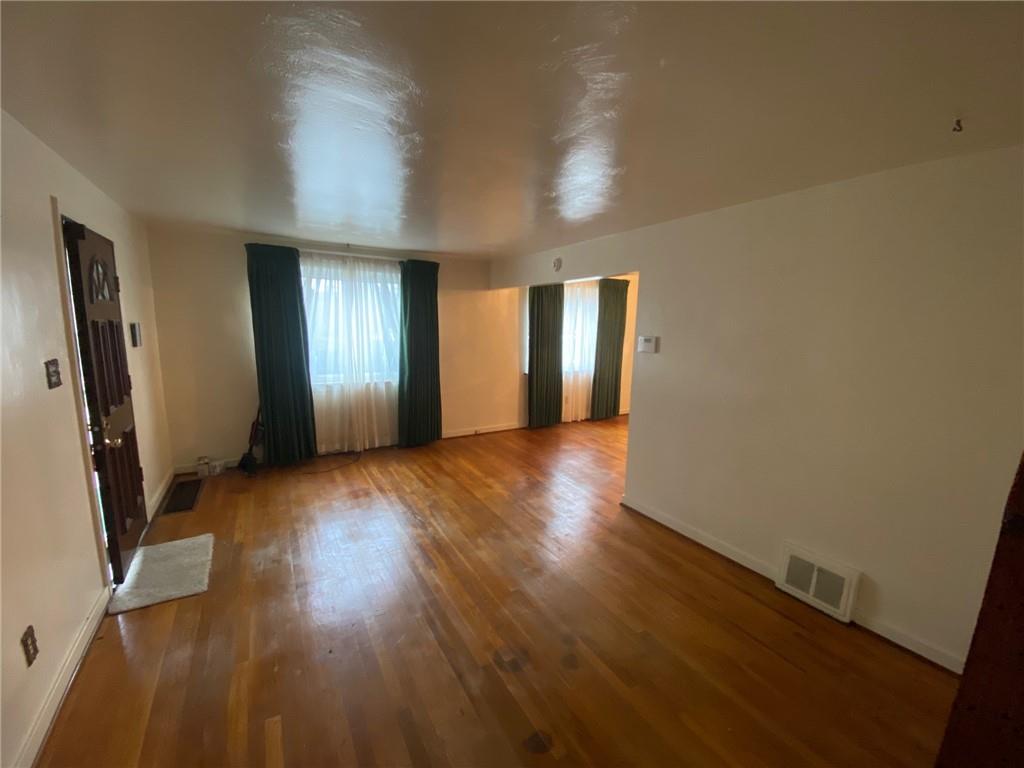 801 Beulah Road Pittsburgh, PA 15235 - Photo 11 of 23 an empty room with wooden floor and windows