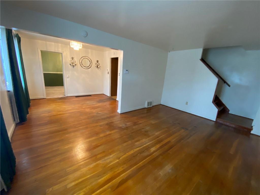 801 Beulah Road Pittsburgh, PA 15235 - Photo 8 of 23 a view of an empty room with wooden floor and a window
